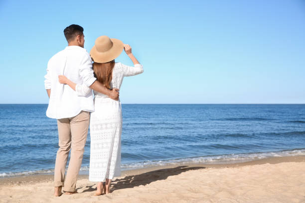 istock Lovely couple on beach. Space for text 1357952760