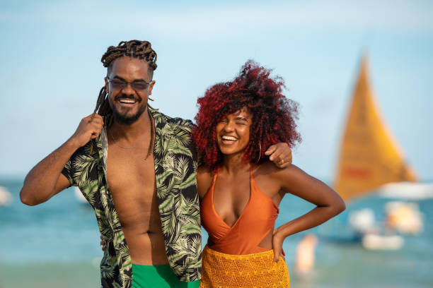 istock Portrait afro couple smiling on the beach 1357954390
