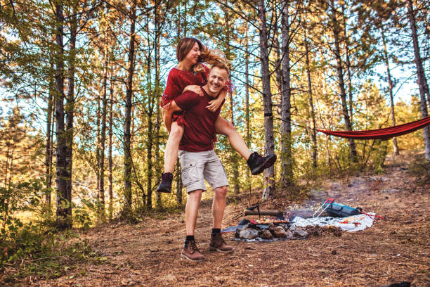 istock Young couple having fun time in the forest 1357954427
