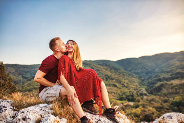 Young couple resting and looking at the mountain view