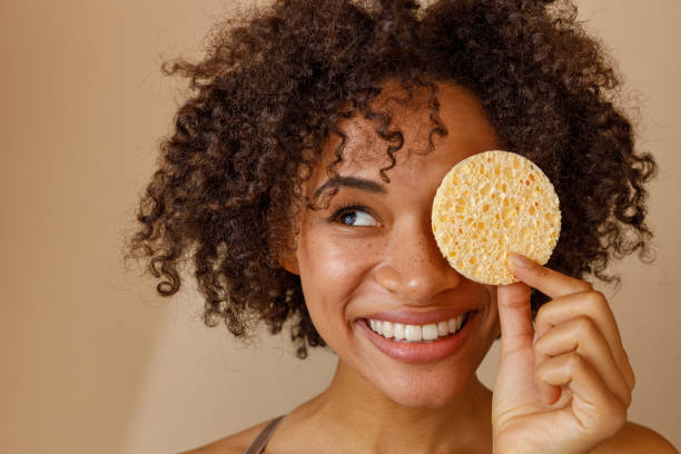 istock Cute lady demonstrating cosmetic tool in studio 1357955204