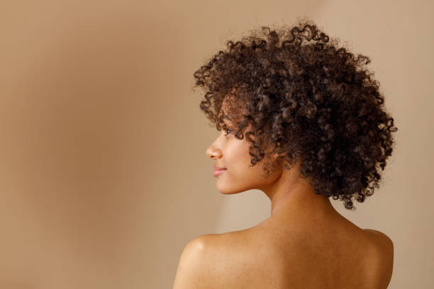 istock Charming multiracial woman posing against beige wall 1357955216