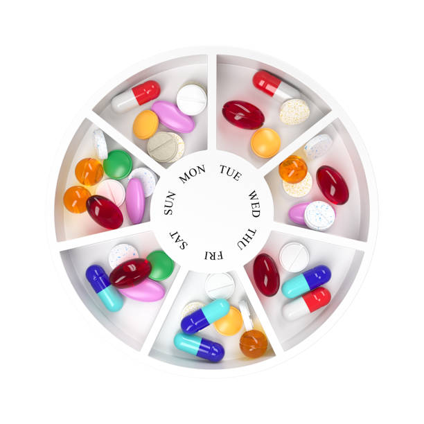 istock Round pill box with different tablets and vitamins for a week. Medication organiser. Top view. 3d rendering. 1357956110