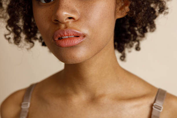 istock Female model with natural makeup posing on beige background 1357956337