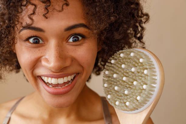 istock Happy lady representing massage brush in studio 1357956353