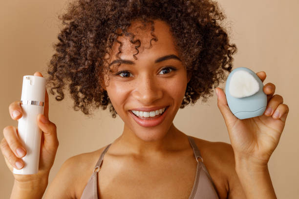 istock Cute lady demonstrating cosmetic tools in studio 1357956380