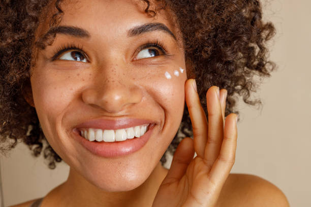 istock Young woman with cream on face in studio 1357956422