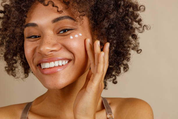 istock Young female model posing against beige wall 1357956424