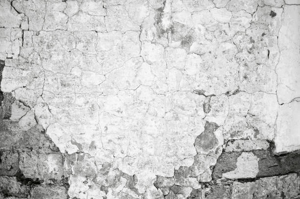 istock Old gray cracked spotted grunge wall texture background 1357957264