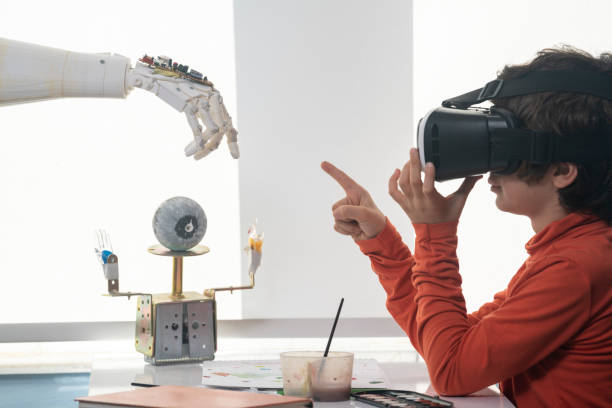 istock Photo Of Elementary Schoolboy Using VR Headset And Interacting With Cyborg 1357959165