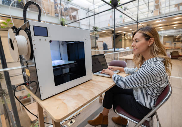 Designer working at the office 3D printing a project