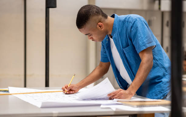 istock Young business man writing a business plan at the office 1357968009