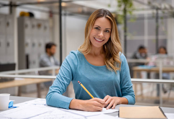 istock Designer working at the office and looking very happy 1357968014