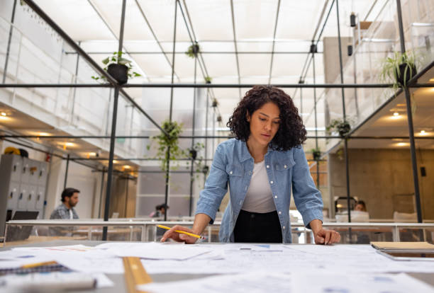 istock Successful woman working at the office creating a business plan 1357968018