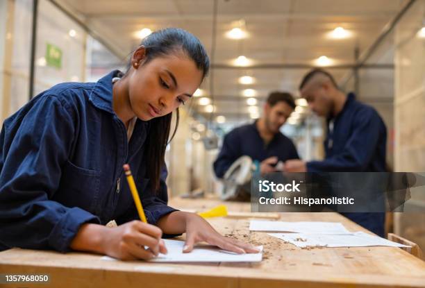 Furniture Designer Drawing A Sketch At A Carpentry Workshop Stock Photo - Download Image Now