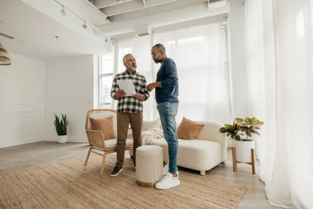 Manager at work as financial consultant talking to elderly people. Senior man meeting health insurance broker or retirement plan agent for signature on agreement