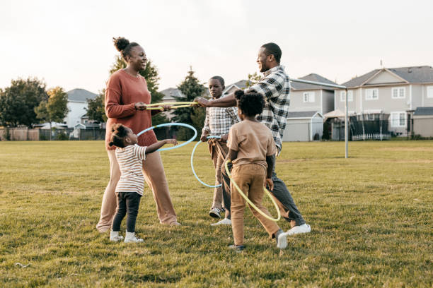 istock Family playing hula hoop outside 1357968668