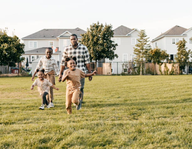 istock Parent.  running outside with three kids 1357968682