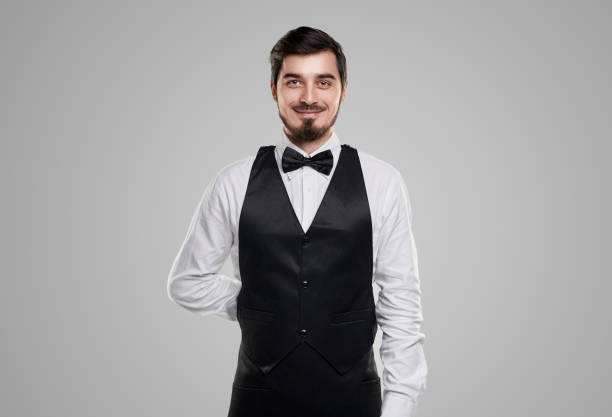 istock Confident smiling waiter in elegant outfit 1357969410