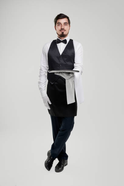 istock Elegant waiter with tray in restaurant 1357969415