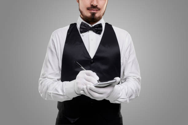istock Elegant waiter taking order from client 1357969432