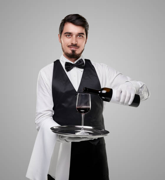 istock Elegant waiter serving wine in restaurant 1357969434