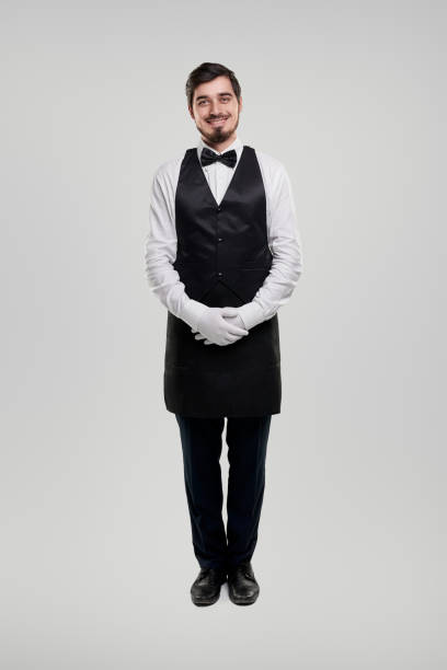istock Friendly waiter in elegant uniform 1357969441