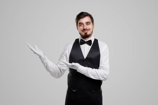 istock Smiling restaurant employee welcoming guests 1357969445