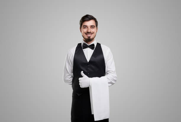 istock Friendly waiter showing thumb up 1357969446