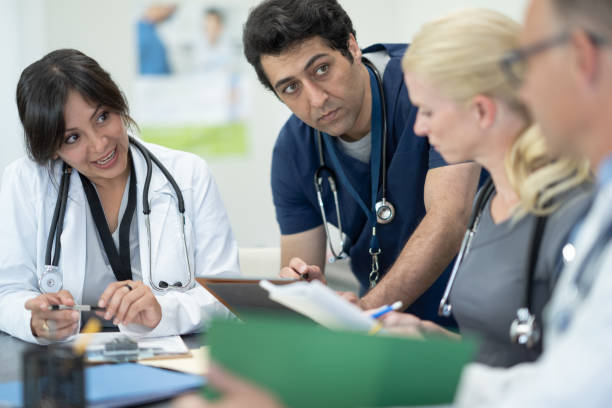 istock Nurse sharing with a Medical Team 1357969642