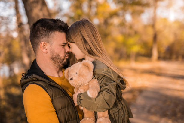 istock Young man playing his little daughter in the park. 1357971134