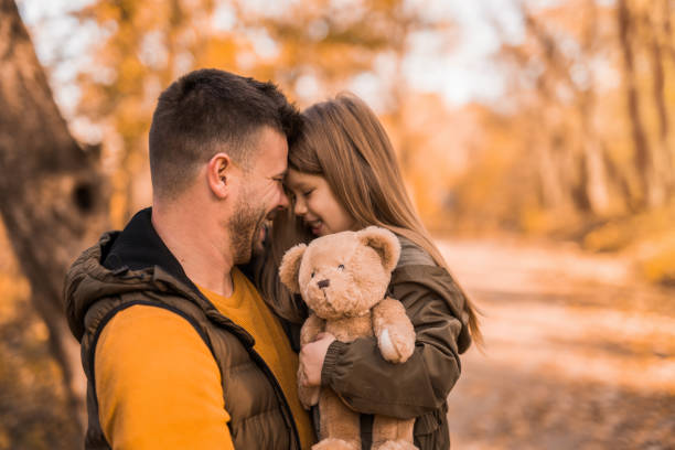 istock Young man playing his little daughter in the park. 1357971188