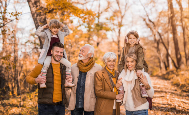 istock Happy multi generational family having fun together in the park. 1357971709