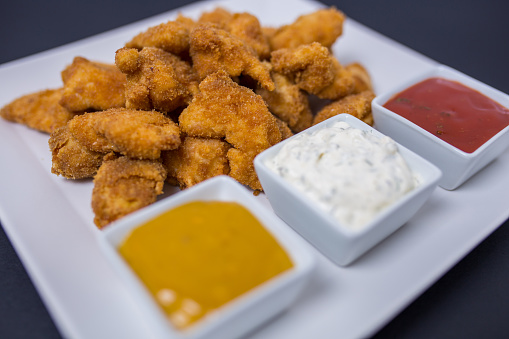 Chicken nuggets with different dipping sauces
