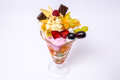 Fresh fruit salad with scoops of ice cream