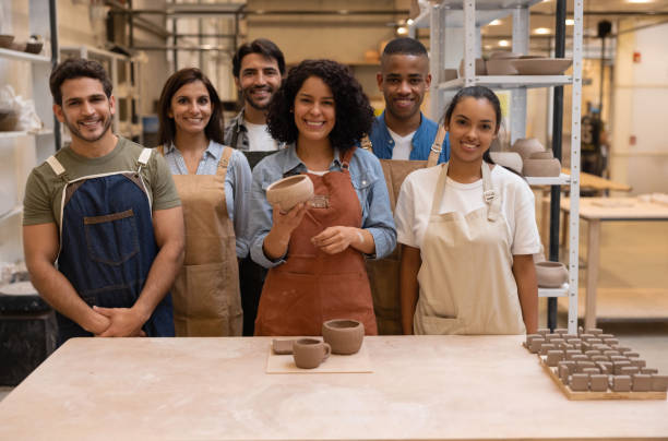 istock Happy group of people in a pottery class 1357976532