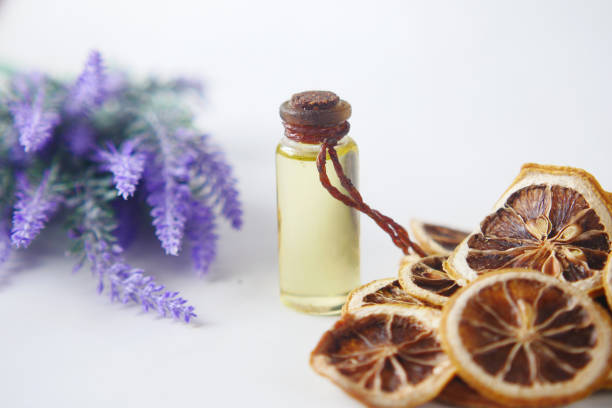 istock Essential lavender oil and flowers on table with copy space 1357979093