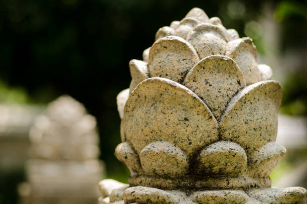 istock Stone column pillars in typical ancient asian art and traditional hand rails with beautiful flower ornaments in front of old local temple 1357985535