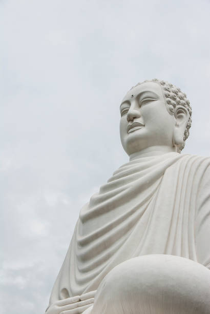 istock White buddha statue in the cloudy sky 1357986400