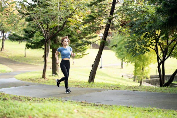 istock Woman running in the park 1357988161