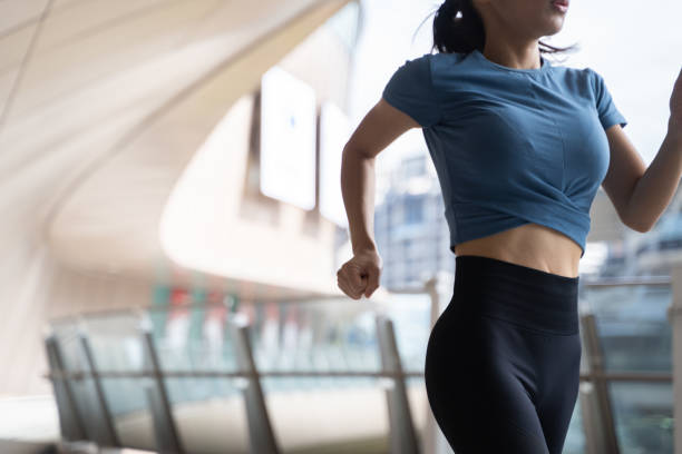 istock Woman running on city bridge 1357988951