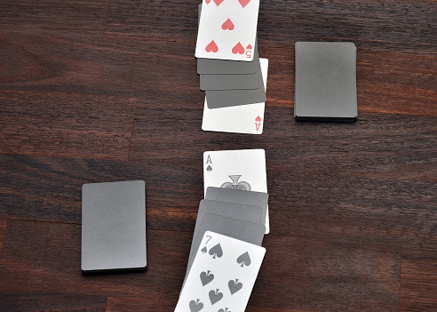 Closeup of a game of war set up with playing cards.