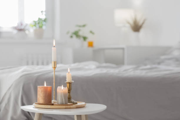 istock burning candles on  white table in bedroom 1357995281