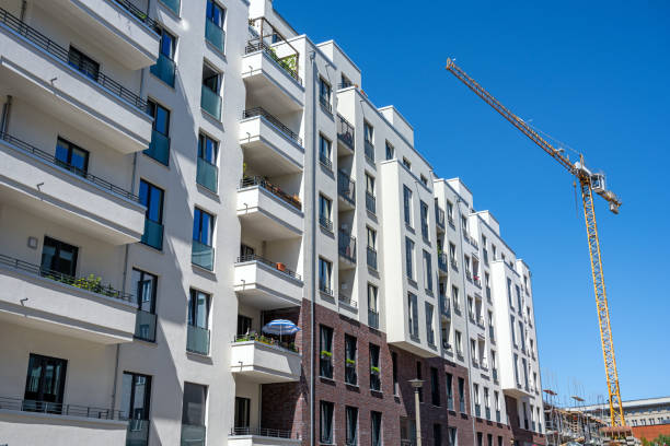 istock Modern apartment buildings with a construction crane 1357998779