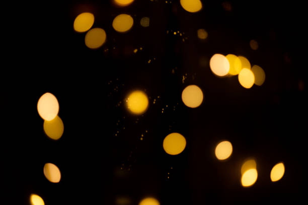 istock black background with golden glittering lights bokeh. abstract defocused pattern 1358001332