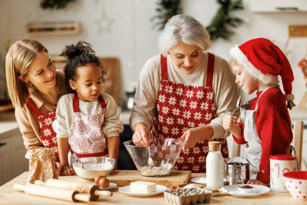 happy multiethnic family, grandmother, mother and kids cooking together on christmas day in kitchen - grandmother cooking baking family imagens e fotografias de stock