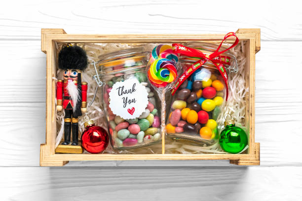 istock Handmade care package, seasonal gift box with candies, cup on white table Personalized eco friendly basket for family, friends, girl for thanksgiving, xmas, Christmas, mothers, fathers day Flat lay 1358004616