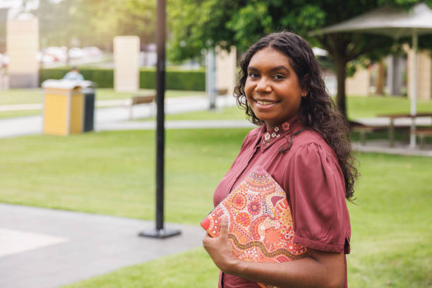 istock Female Aboriginal Australian Student Holding Laptop 1358004629