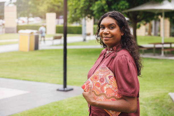 istock Female Aboriginal Australian Student Holding Laptop 1358004631