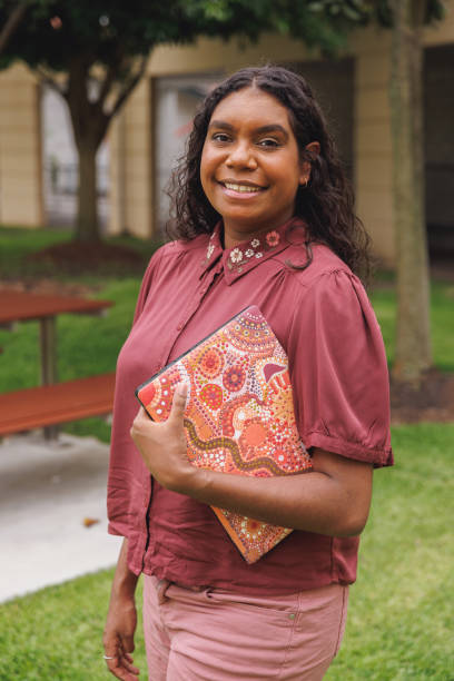 istock Female Aboriginal Australian Student Holding Laptop 1358004802